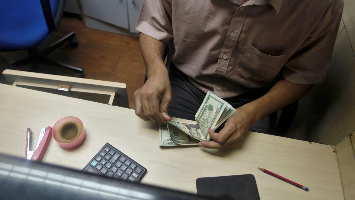 Rupee falls by 15 paise against US dollar due to muted equity markets,