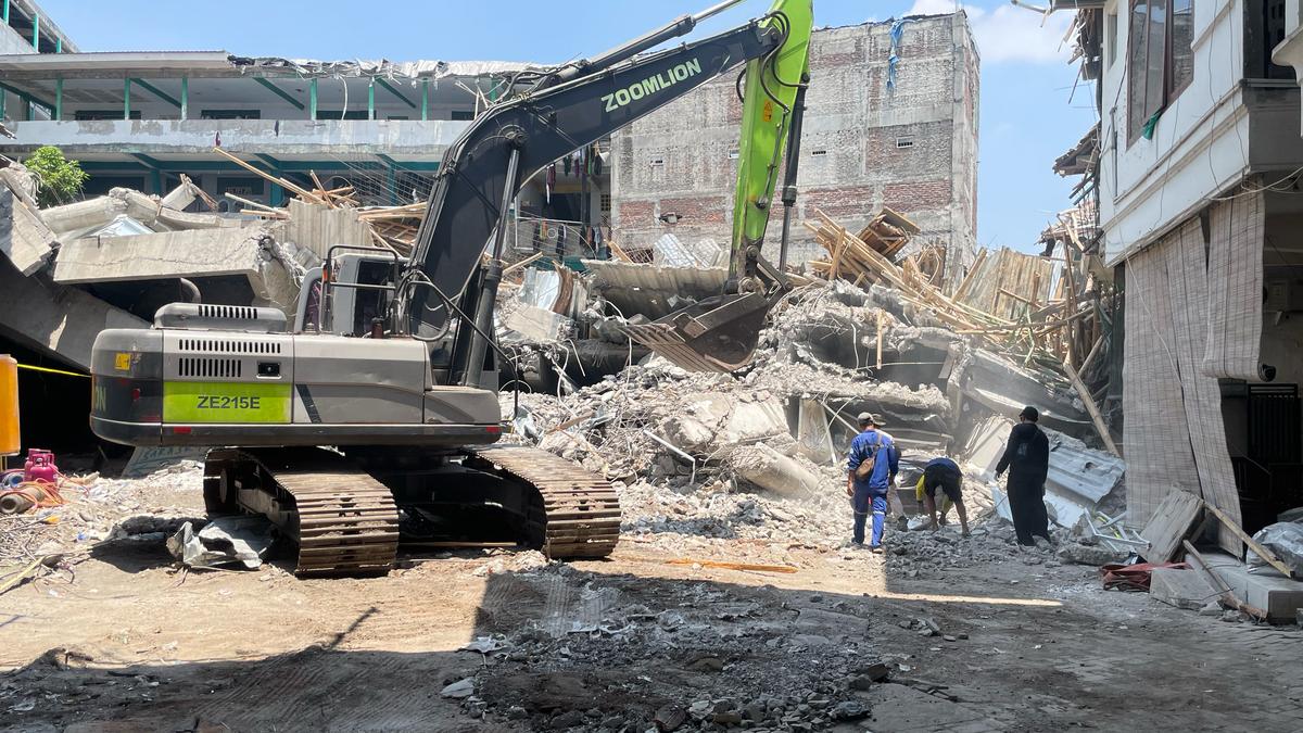 Indonesian crews pull 3 bodies from rubble of collapsed school with more than 50 boys still missing