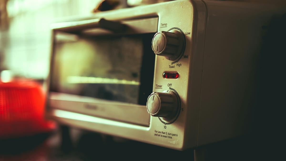 Why do microwave ovens sometimes overheat water?