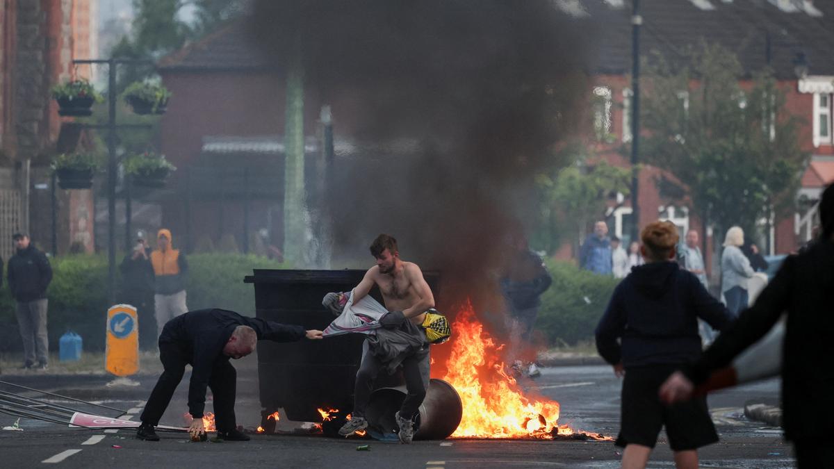 Protesters torch vehicles, block roads over Belfast stabbing