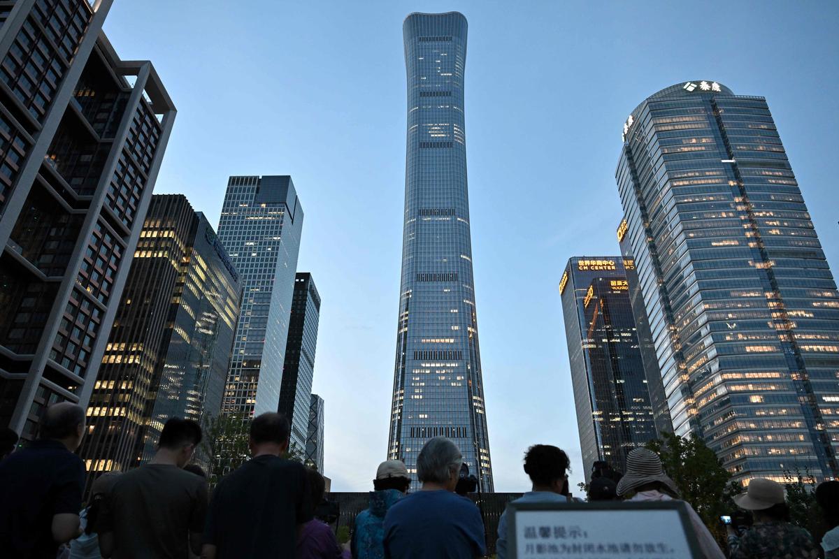 Fragments fall after an aircraft hits Beijing’s tallest building. 